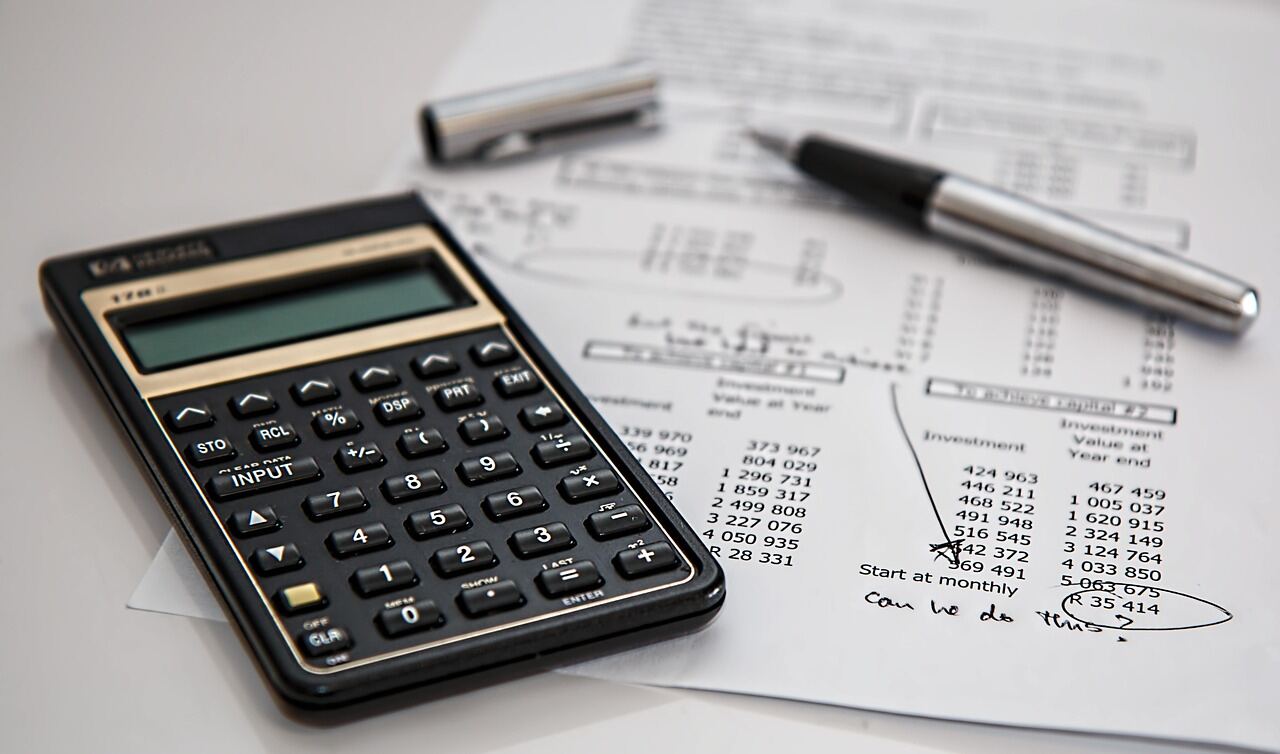 Reviewing financial documents with a calculator